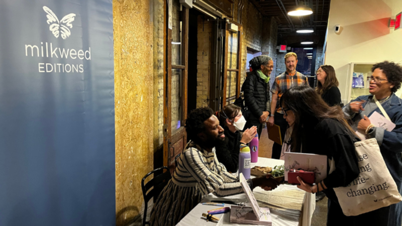 Photograph of JJJJJeromeEllis signing books at Open Book